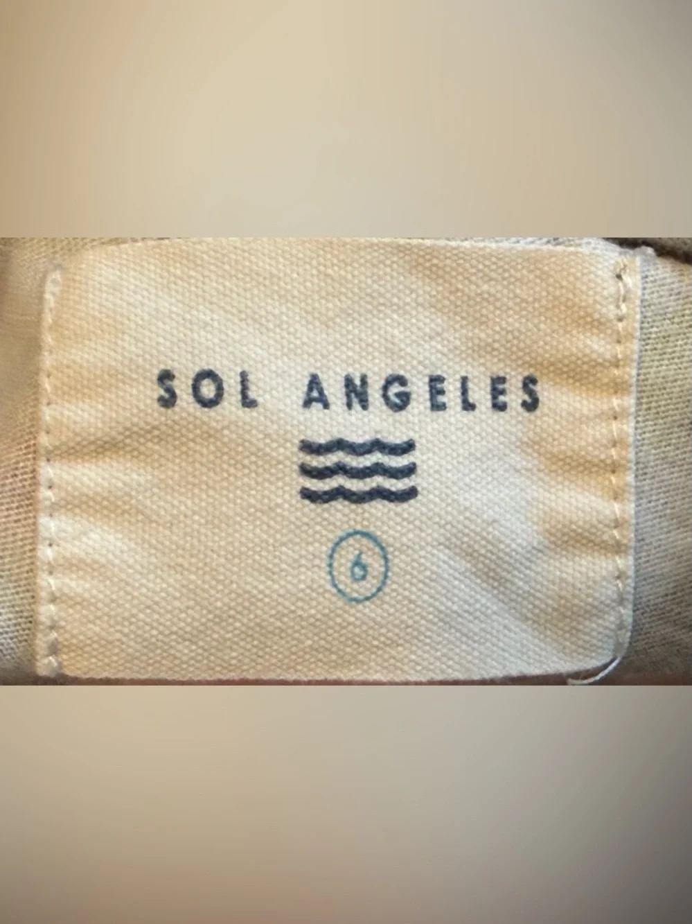 Sol Angeles Cream Label with Navy and Teal Accents